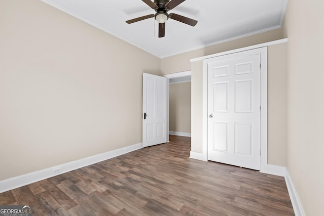 unfurnished bedroom featuring wood-type flooring, ceiling fan, and ornamental molding