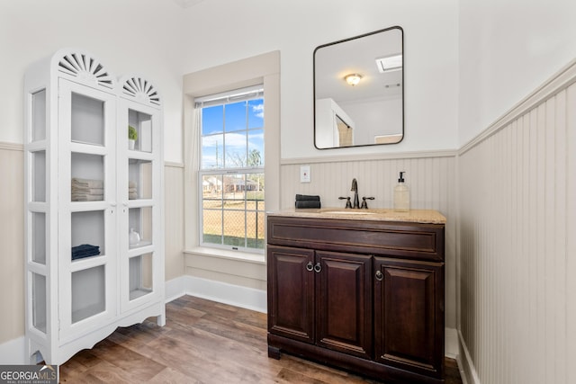 bathroom with vanity and wood-type flooring