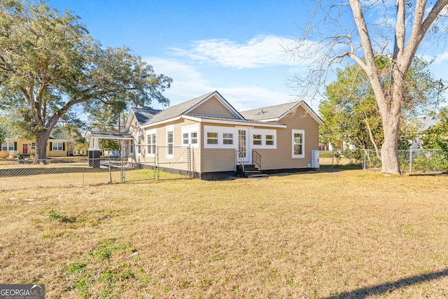 back of property featuring a lawn