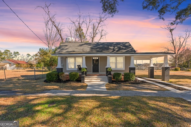 view of front of property featuring a lawn and covered porch