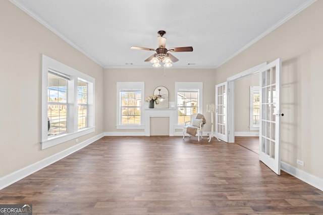 unfurnished living room with ceiling fan, dark hardwood / wood-style flooring, french doors, and ornamental molding