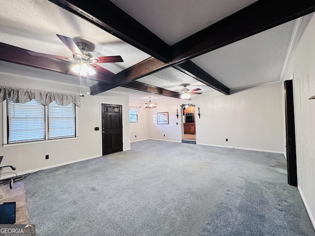 unfurnished living room featuring ceiling fan with notable chandelier, coffered ceiling, beamed ceiling, and carpet flooring