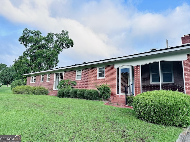 ranch-style house with a front lawn