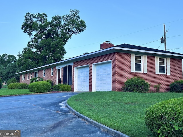 ranch-style house with a front yard and a garage