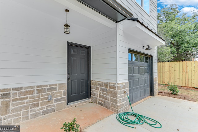 view of exterior entry featuring a garage