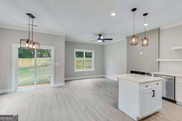 kitchen featuring decorative light fixtures, white cabinets, stainless steel dishwasher, and ceiling fan