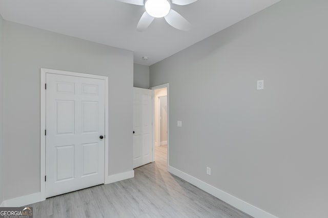 unfurnished bedroom with ceiling fan and light hardwood / wood-style flooring