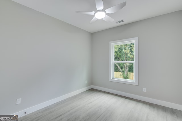 spare room with ceiling fan and light wood-type flooring