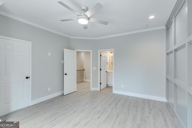 unfurnished bedroom featuring ceiling fan, crown molding, light hardwood / wood-style flooring, and ensuite bath