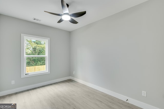 empty room with ceiling fan and light wood-type flooring