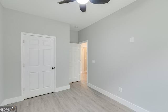 unfurnished bedroom with ceiling fan and light hardwood / wood-style flooring