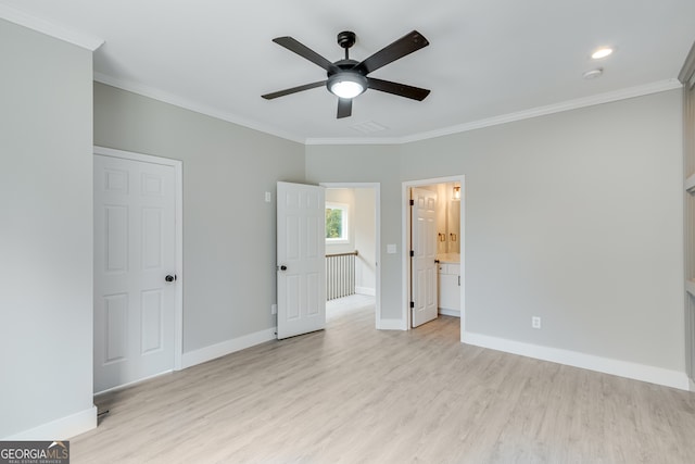 unfurnished bedroom featuring ensuite bath, ceiling fan, and crown molding