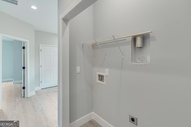 laundry area featuring light hardwood / wood-style flooring, hookup for a washing machine, and hookup for an electric dryer