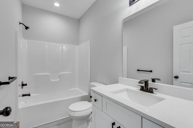 full bathroom featuring toilet, wood-type flooring, vanity, and shower / tub combination