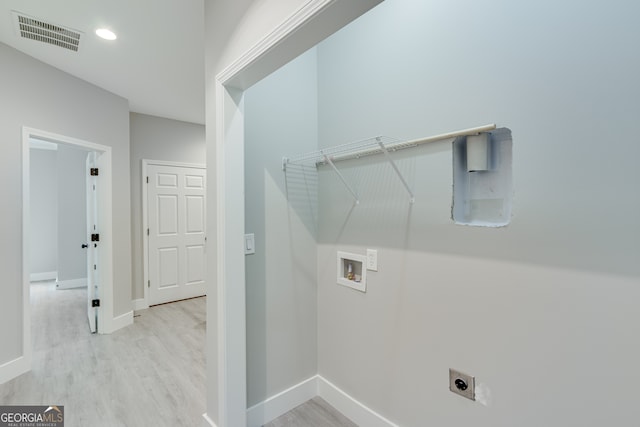 laundry room featuring washer hookup, light hardwood / wood-style flooring, and hookup for an electric dryer