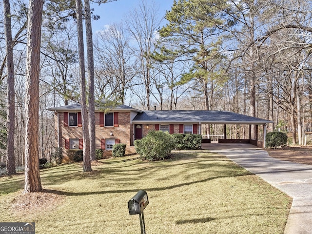 tri-level home featuring a carport and a front lawn