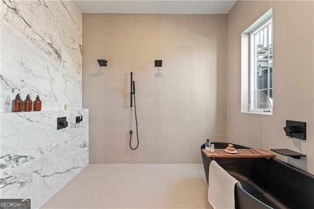 bathroom featuring tile walls and a tile shower