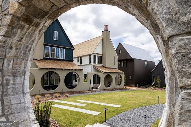 rear view of house featuring a lawn