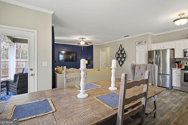 dining area featuring ceiling fan, crown molding, and dark hardwood / wood-style floors