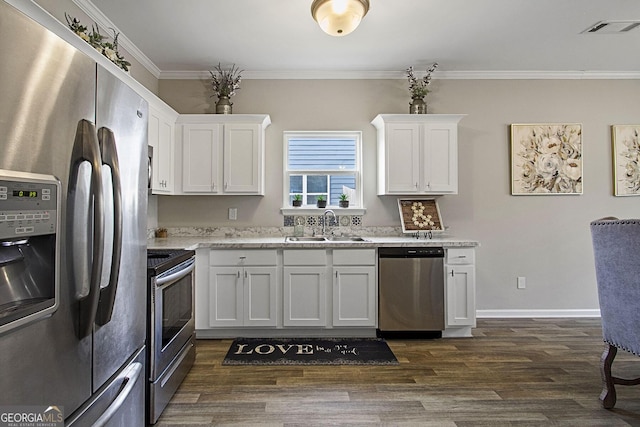 kitchen with dark hardwood / wood-style floors, stainless steel appliances, crown molding, white cabinetry, and sink