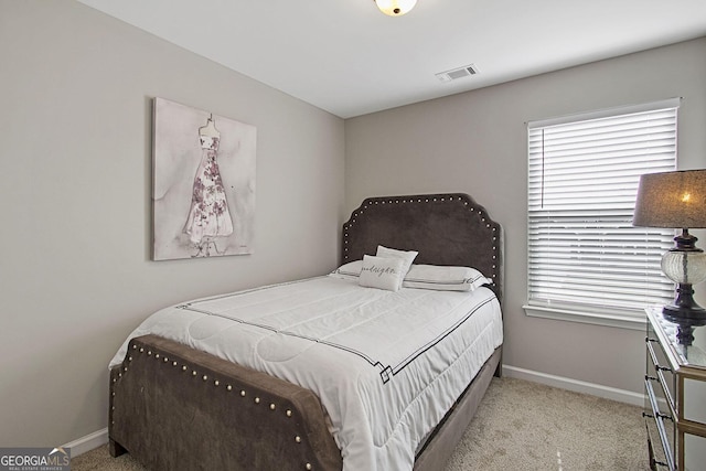 bedroom with light colored carpet