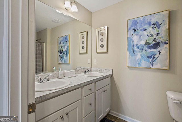 bathroom with toilet and vanity