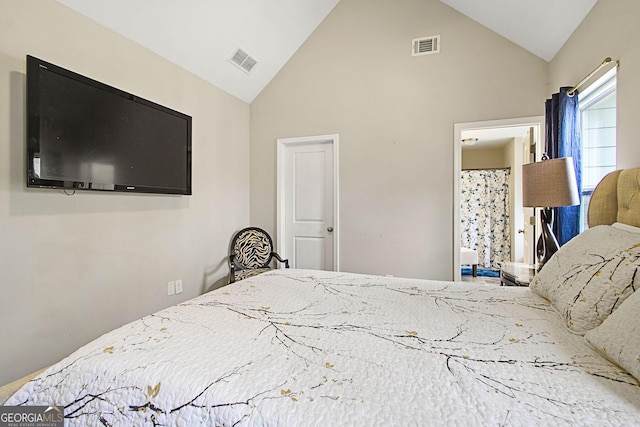 bedroom with high vaulted ceiling