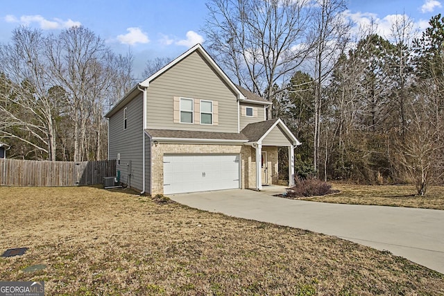 front facade featuring a front yard, a garage, and central AC