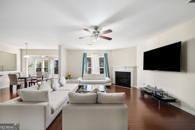 living room featuring dark hardwood / wood-style floors and ceiling fan