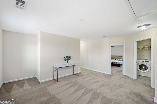 laundry room with washer / clothes dryer and light carpet