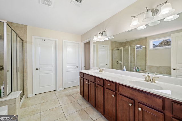 bathroom with vanity, tile patterned floors, and a shower with door