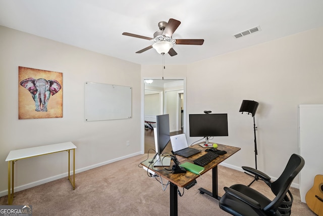 office space with ceiling fan and light colored carpet