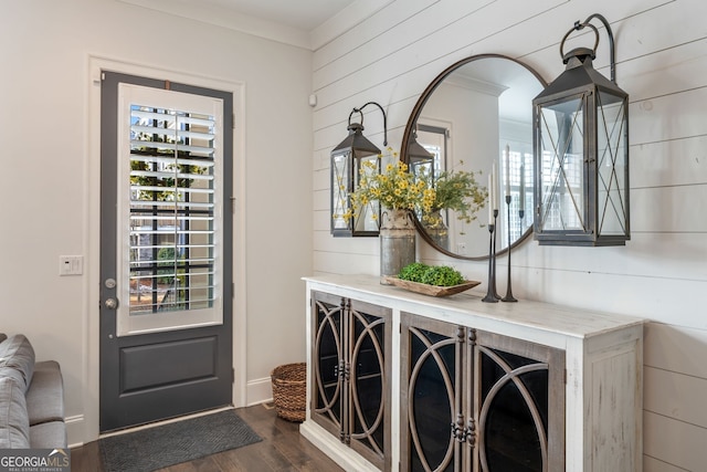 entryway with crown molding and dark hardwood / wood-style flooring