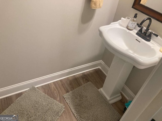 bathroom with hardwood / wood-style floors