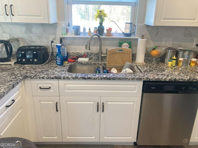 kitchen with backsplash, white cabinetry, and dishwasher