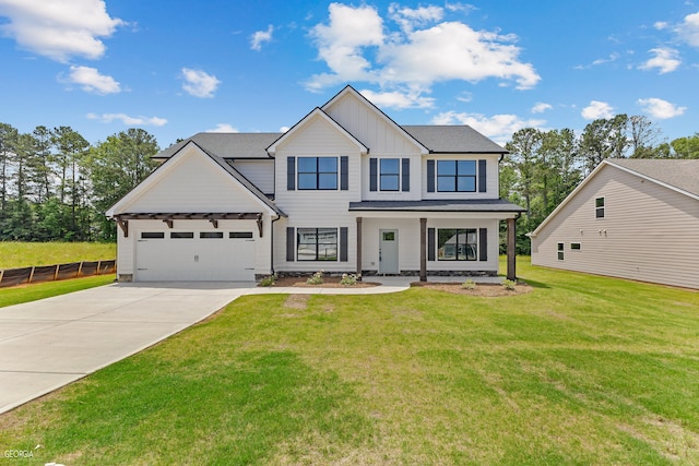 view of front of house with a garage, a porch, and a front yard