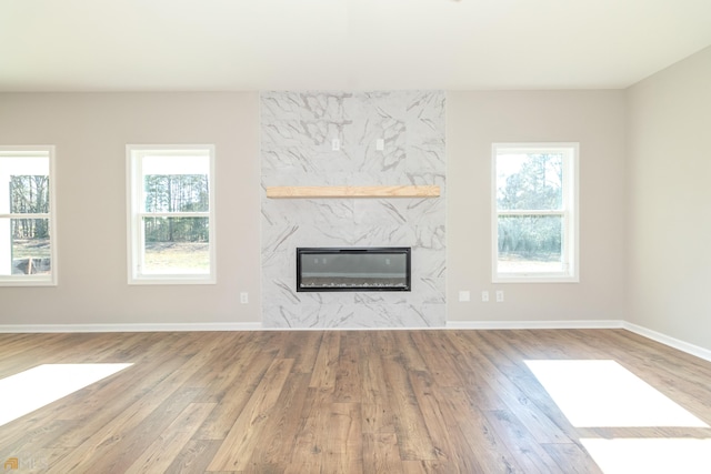 unfurnished living room with a fireplace and hardwood / wood-style flooring