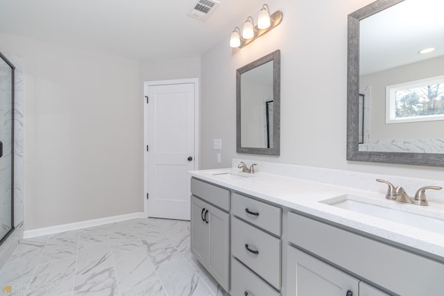 bathroom with a shower with door and vanity