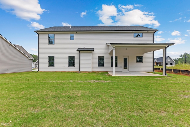 back of property featuring a patio and a yard