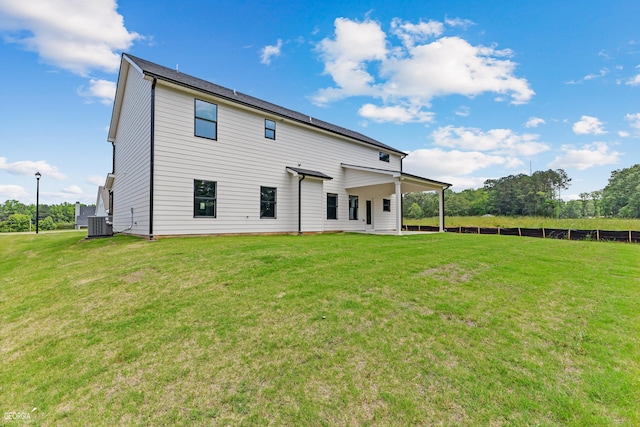 back of house with a lawn