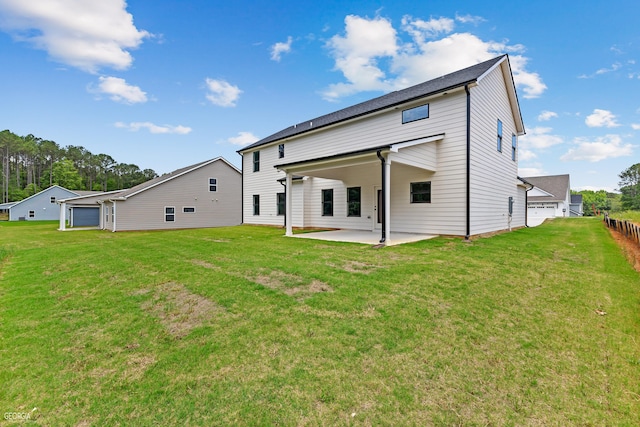 back of house featuring a patio area and a lawn