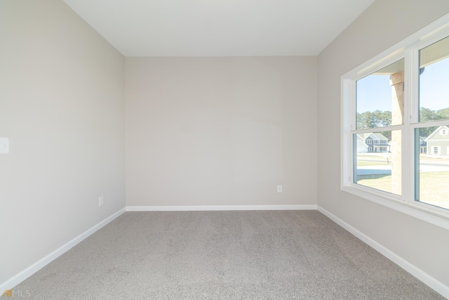 unfurnished room featuring a wealth of natural light and carpet floors