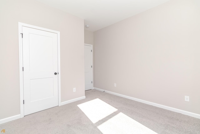 unfurnished bedroom featuring light colored carpet