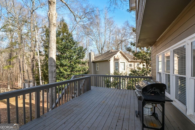 wooden terrace featuring area for grilling