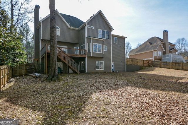103 Ashwood Ct N, Stockbridge, GA 30281 - back of house with stairway, a wooden deck, a fenced backyard, and a chimney