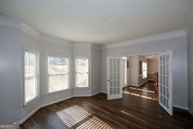 unfurnished room featuring french doors, dark hardwood / wood-style floors, and crown molding