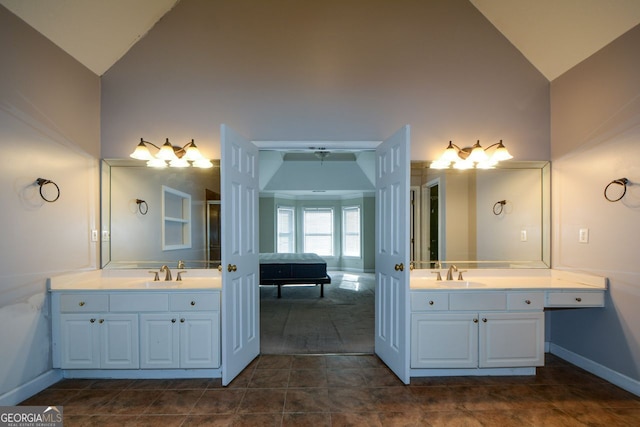 bathroom featuring vanity, tile patterned flooring, and high vaulted ceiling