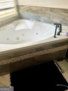 bathroom featuring tile patterned floors and tiled tub