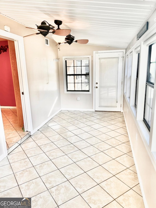 tiled spare room featuring ceiling fan