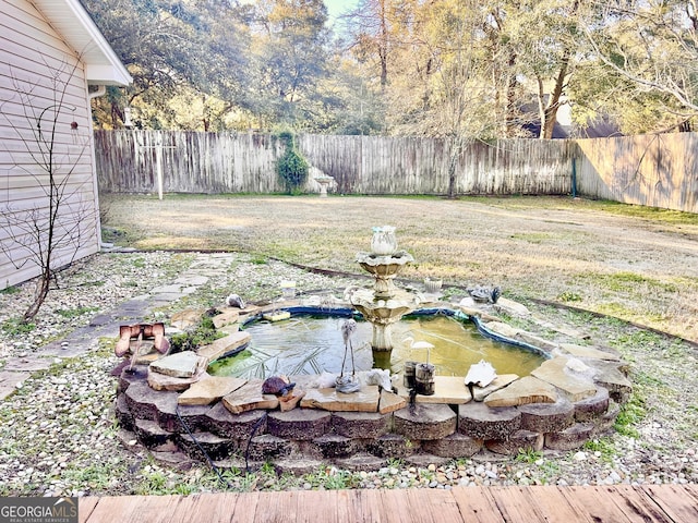 view of yard featuring a garden pond